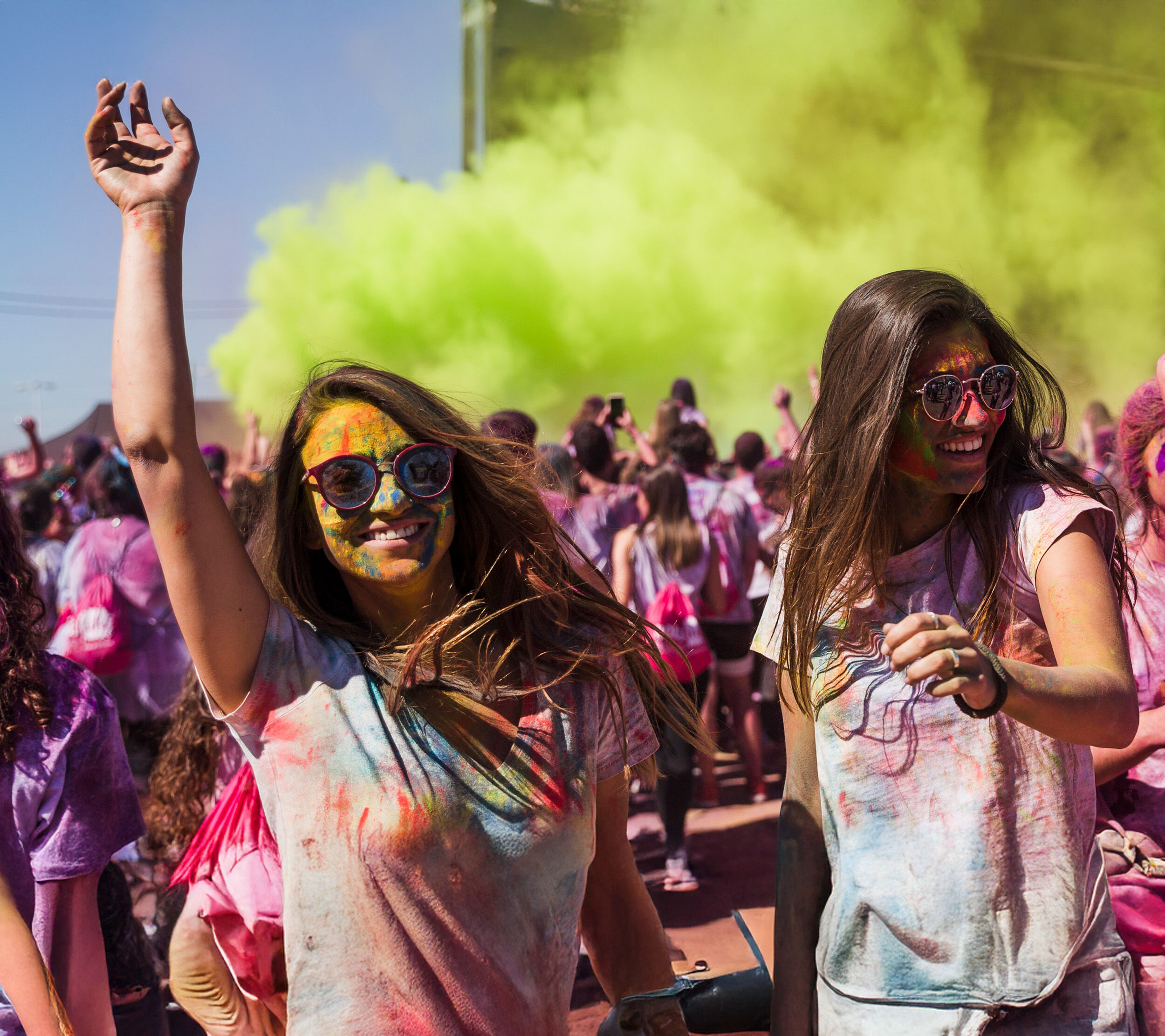Young Women Enjoying Holi Festival of Colors Outdoors